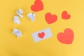 A white envelope lies with red hearts on a yellow background. Unsuccessful emails Royalty Free Stock Photo