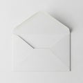 White envelope lying on a plain surface, open with its flap lifted. Made of smooth paper, exhibiting Royalty Free Stock Photo