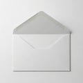 White envelope with open flap, made from smooth paper. Lies on a solid light-colored surface. The Royalty Free Stock Photo