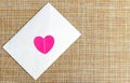 A white envelope with a pink heart. Love letter. Invitation to the wedding. Royalty Free Stock Photo