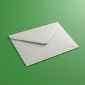 White envelope placed on a smooth green surface, showcasing its clean, folded Royalty Free Stock Photo