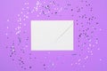 White Envelope on Purple Background and Confetti, Top View