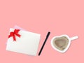 white envelope with red ribbon bow and invitation or greeting card, pen and cappuccino in heart shape coffee cup Royalty Free Stock Photo