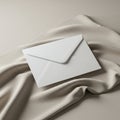 A white envelope rests on a flowing, textured beige fabric backdrop. The envelope is Royalty Free Stock Photo