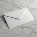 A white envelope on a smooth, light gray marble surface with dark veining. The envelo Royalty Free Stock Photo