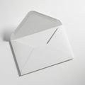 A white envelope on a white surface, opened with its flap raised. The envelope has a classic Royalty Free Stock Photo