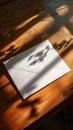 White envelope on wooden table with shadows, natural light and still life concept Royalty Free Stock Photo