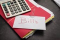 White envelope with the word bills written on it with paper clip arrow pointing Royalty Free Stock Photo