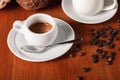 White espresso coffee Cup, coffee beans and milk jug on wooden background. Concept of coffee breaks and serving coffee Royalty Free Stock Photo