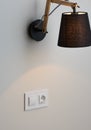 White European electrical socket and switch on the gray wall. St