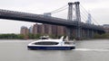 White excursion motor boat underway on the East River on background, of Williamsburg Bridge, New York, NY, USA Royalty Free Stock Photo