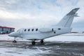 White executive airplane at winter airport apron