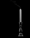 White extinguished candle on a black background Royalty Free Stock Photo
