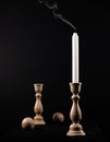 White extinguished candle on a black background Royalty Free Stock Photo