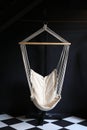 White fabric cradle hang indoor at dark living room. Hammock hanging swing against black wall Royalty Free Stock Photo