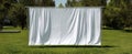 The white fabric curtain standing in a tranquil outdoor setting with greenery. AI generated image Royalty Free Stock Photo