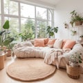 White fabric sofa with peach color blanket between green houseplant. Round knitted rug against of window. Nordic interior design