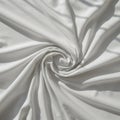 White fabric swirled into a spiral pattern, creating a central focal point. The material Royalty Free Stock Photo