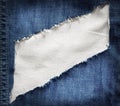 White fabric texture with torn blue jeans Royalty Free Stock Photo