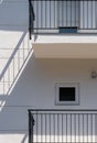 White facade of a flat building with minimalist design and small windows. Royalty Free Stock Photo