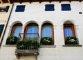 White facade and flowered of a building in Oderzo in the province of Treviso in the Veneto (Italy) Royalty Free Stock Photo