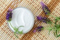 White facial mask face cream, hair treatment, body butter in a small jar and lavender flowers. Natural skin and hair care Royalty Free Stock Photo