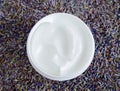 White facial mask face cream, shea butter, hair mask, body butter in the small white container. Natural skin and hair concept.