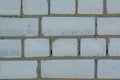 White faded old bricks background with flaws and splits Royalty Free Stock Photo