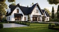 White family house with black pitched roof tiles, and beautiful front yard with green lawn Royalty Free Stock Photo