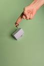 White family paper house. House keys in hand on mint background paper. Minimalistic and simple concept, style. Copy space. Royalty Free Stock Photo