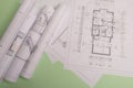 White family paper house , stack of money coins, house projects plan and blueprints on mint background paper. Minimalistic and Royalty Free Stock Photo