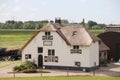 White farmhouse called Meerkoetenerf with thatched roof along the dike of the Hollandsche IJssel river on Hitland Royalty Free Stock Photo