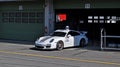 White fast sports car Porsche 911 stands in the garage during a show on the circuit in Brno and is preparing for the races.