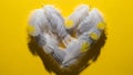 White Feather Heart on Yellow Background Royalty Free Stock Photo