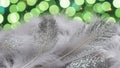 White Feathers with Sparkles and Green Bokeh Background Royalty Free Stock Photo