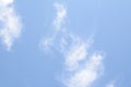 White feathery clouds on blue sky