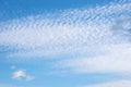 White feathery fluffy clouds on a blue sky, background and texture. Cirrus clouds in the blue sky Royalty Free Stock Photo