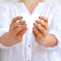 White felted heart in femaile hands with rainbow manicure. Love, valentine, lgbt, pride concept Royalty Free Stock Photo