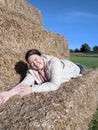 White Female lying on hay bales autumn England countryside