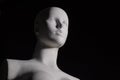 A white female manikin in low angle shot with black backgound Royalty Free Stock Photo