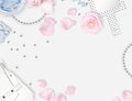 White feminine background. Flat lay. Pink roses, mirror, leaves, gift, bag.