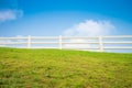 White fence on green field and blue sky - Green environmental co