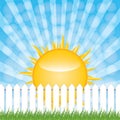 White fence and green grass on blue sky background