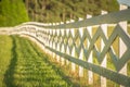 White fence leading up to a big red barn Royalty Free Stock Photo