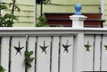 White fence with starfish cut outs and arbor at coast