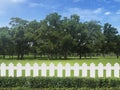 White fences on green grass and the trees behind with blue sky Royalty Free Stock Photo