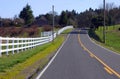 White fences & road. Royalty Free Stock Photo