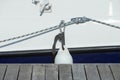 White fender suspended between a boat and dockside for protection. Maritime fenders
