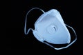 White ffp3 face mask with a valve on a black background Royalty Free Stock Photo
