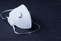 White ffp3 face mask with a valve on a dark background Royalty Free Stock Photo